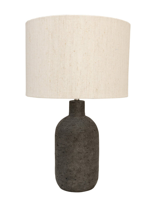 Handmade table lamp with earthy terracotta base and linen shade.